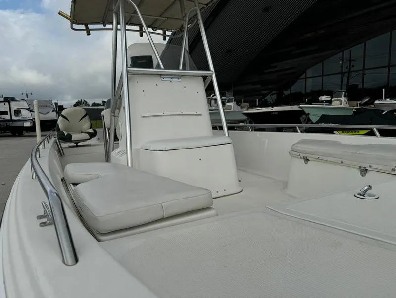 Slide: The Image of 2001 Bay Stealth 2230 boat with seating and console, docked outdoors. - 13