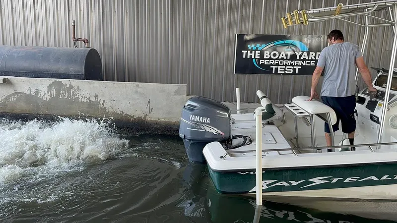Slide: The Image of Bay Stealth 2230 boat undergoing performance test in water, Yamaha engine visible. - 16