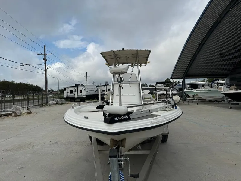 Slide: The Image of 2001 Bay Stealth 2230 boat on trailer under cloudy sky. - 3
