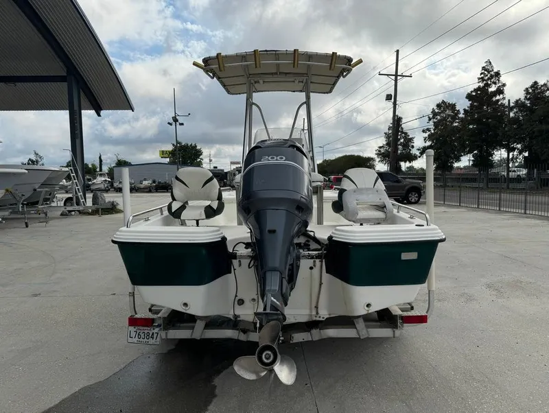 Slide: The Image of 2001 Bay Stealth 2230 boat with outboard motor, parked outdoors. - 7