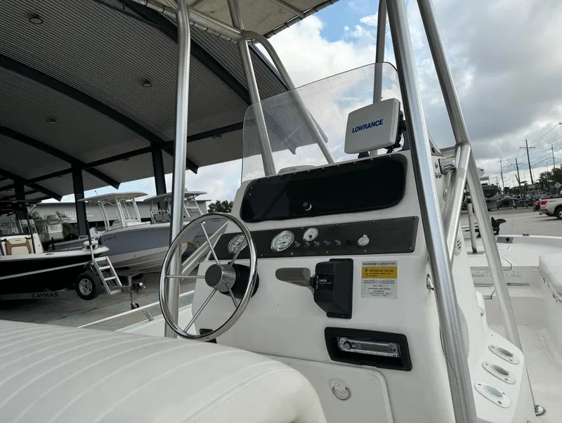 Slide: The Image of 2001 Bay Stealth 2230 boat console with steering wheel and gauges. - 9