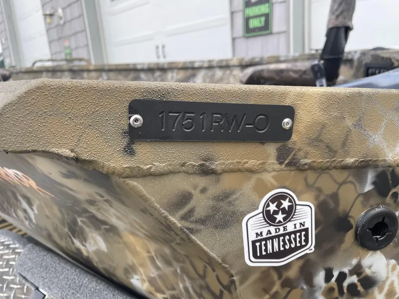 Slide: The Image of Excel 1751 River Warrior 2025 boat with camouflage design, "Made in Tennessee" sticker. - 14