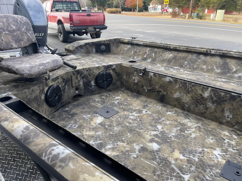 Slide: The Image of 2025 Excel 1751 River Warrior boat with camo design and seating. - 8