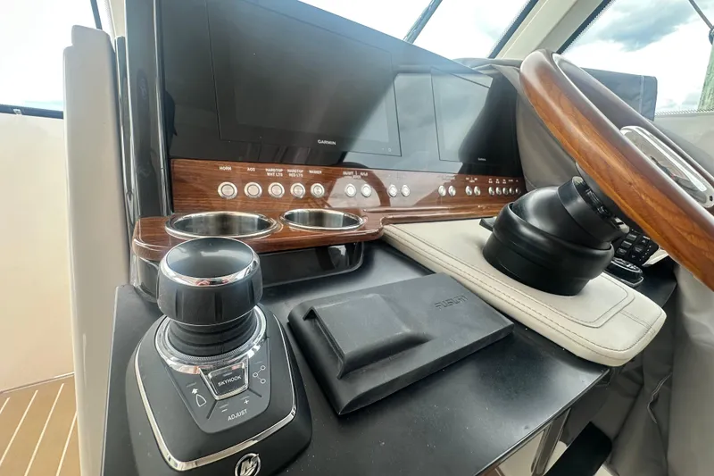 Slide: The Image of 2026 Tiara Yachts 34 LX helm with advanced controls and navigation displays. - 11