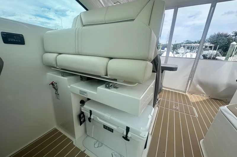 Slide: The Image of 2026 Tiara Yachts 34 LX interior with cushioned seating and Yeti cooler on deck. - 12