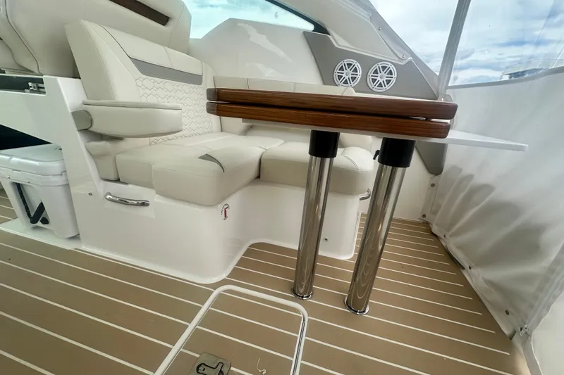 Slide: The Image of 2026 Tiara Yachts 34 LX interior with elegant seating and wooden table. - 14