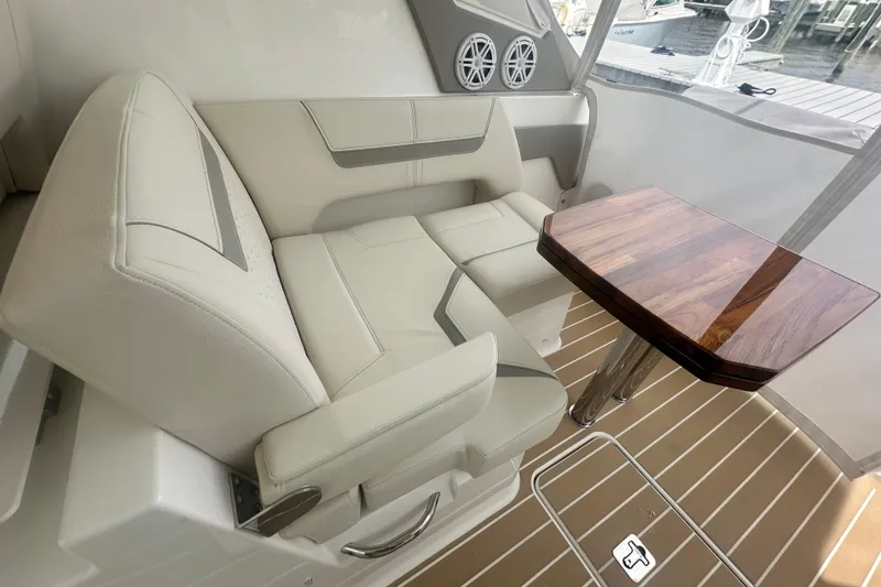 Slide: The Image of Luxurious seating area on 2026 Tiara Yachts 34 LX with elegant wooden table. - 16