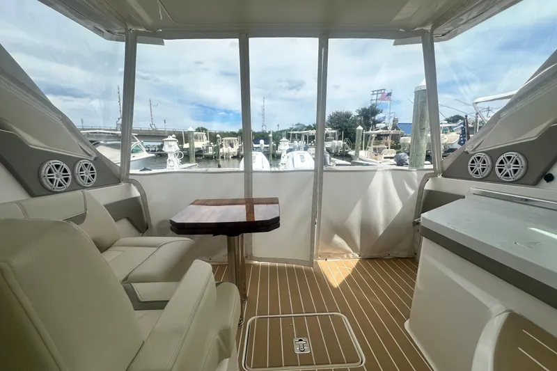 Slide: The Image of Interior of 2026 Tiara Yachts 34 LX, featuring seating and a wooden table. - 17