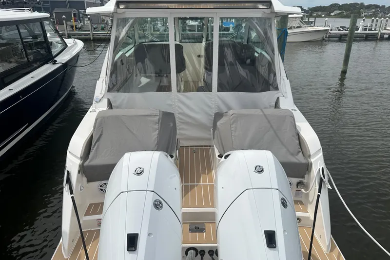 Slide: The Image of 2026 Tiara Yachts 34 LX with dual engines docked at marina. - 19