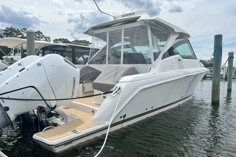 Slide: The Image of 2026 Tiara Yachts 34 LX boat docked, featuring Mercury engines and Garmin equipment. - 20