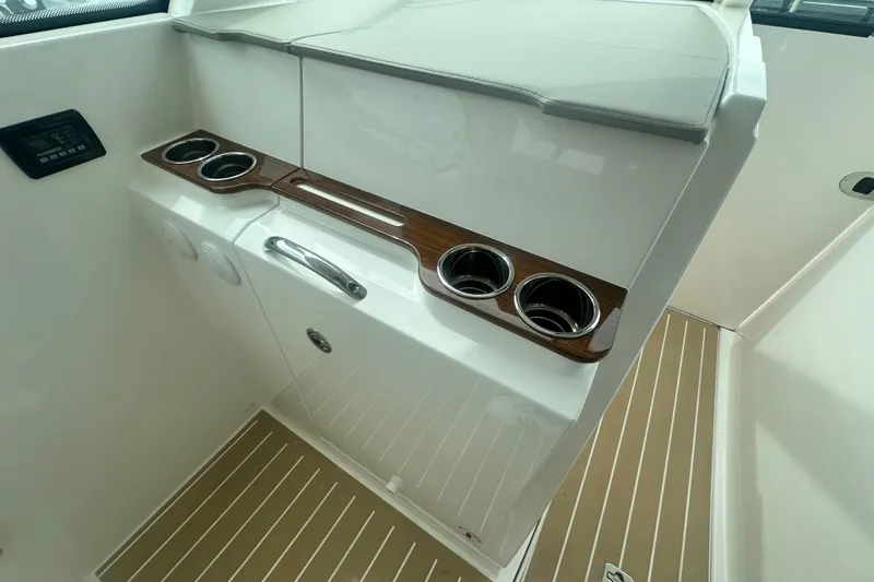 Slide: The Image of 2026 Tiara Yachts 34 LX interior with cup holders and sleek design. - 8