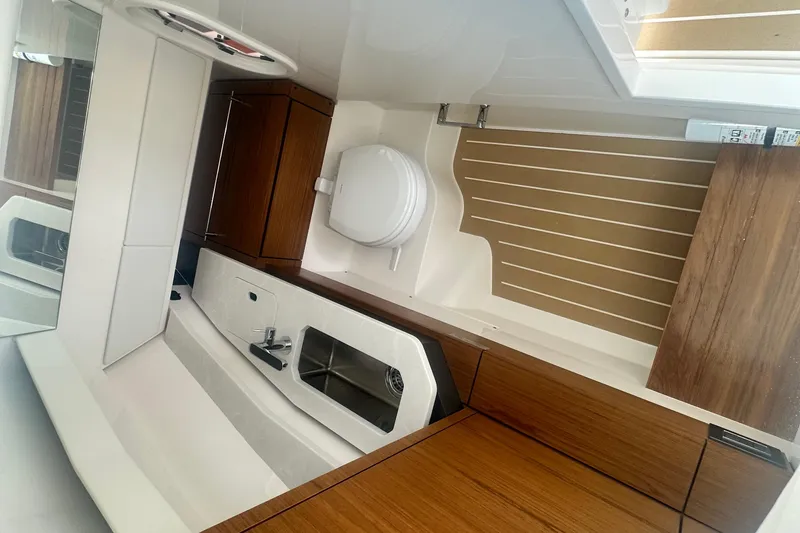 Slide: The Image of 2026 Tiara Yachts 34 LX interior with modern wood cabinetry and sleek sink design. - 9