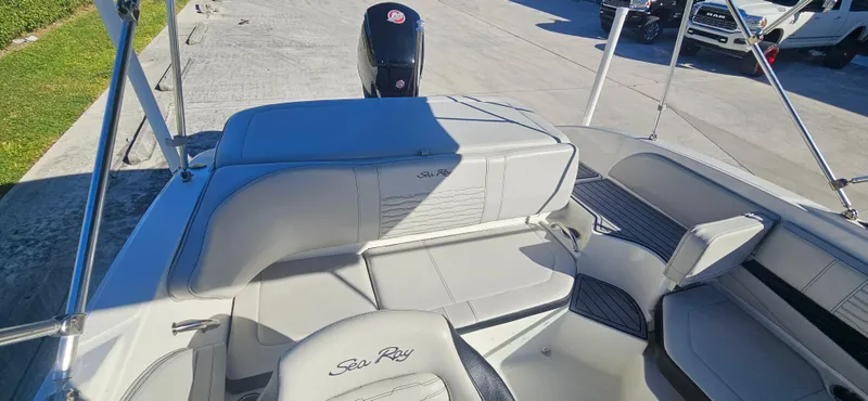 Slide: The Image of 2021 Sea Ray SPX 190 OB boat interior with seating and outboard motor. - 11