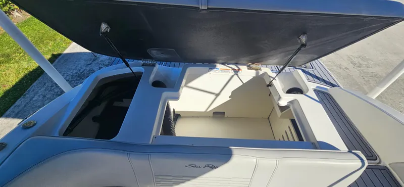 Slide: The Image of 2021 Sea Ray SPX 190 OB boat storage compartments open, showcasing interior space. - 12