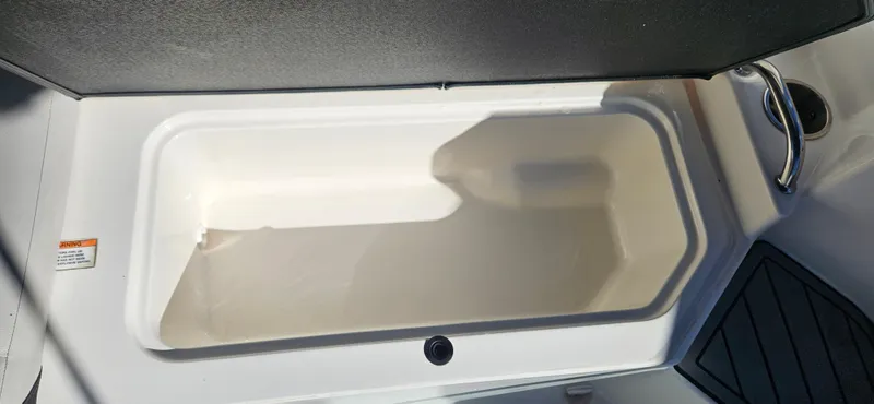 Slide: The Image of 2021 Sea Ray SPX 190 OB storage compartment, open and empty. - 13