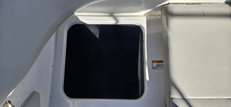 Slide: The Image of 2021 Sea Ray SPX 190 OB boat interior with storage compartment. - 14