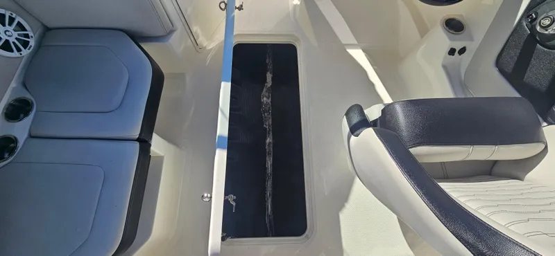 Slide: The Image of Interior view of 2021 Sea Ray SPX 190 OB boat, featuring seating and storage. - 15