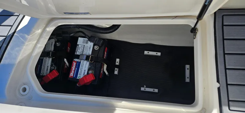Slide: The Image of 2021 Sea Ray SPX 190 OB boat battery compartment with two batteries. - 16