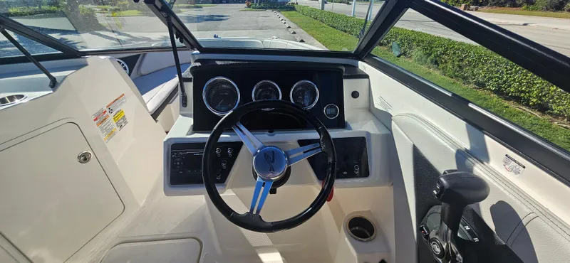 Slide: The Image of 2021 Sea Ray SPX 190 OB boat dashboard with steering wheel and gauges. - 17