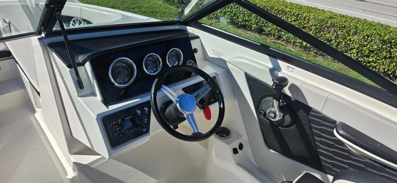 Slide: The Image of 2021 Sea Ray SPX 190 OB boat dashboard with steering wheel and controls. - 18