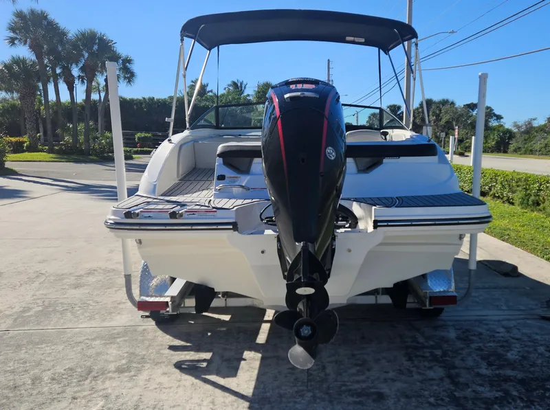 Slide: The Image of 2021 Sea Ray SPX 190 OB boat with outboard motor, parked on a sunny driveway. - 3
