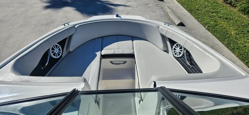 Slide: The Image of 2021 Sea Ray SPX 190 OB boat interior with cushioned seating and speakers. - 4