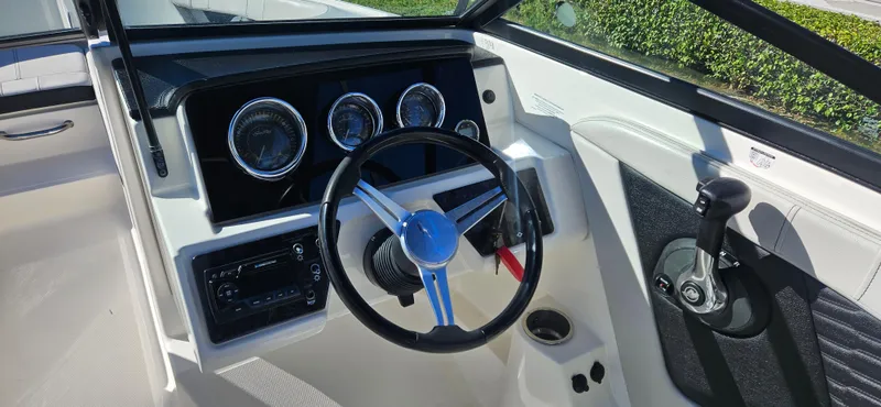 Slide: The Image of 2021 Sea Ray SPX 190 OB boat dashboard with steering wheel and controls. - 6