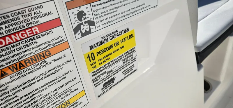 Slide: The Image of Capacity warning label on 2021 Sea Ray SPX 190 OB boat, maximum 10 persons or 1477 lbs. - 8
