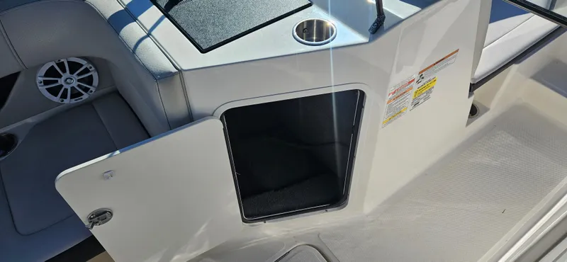 Slide: The Image of 2021 Sea Ray SPX 190 OB boat interior with open storage compartment. - 9