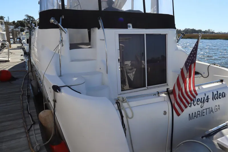 Slide: The Image of 2005 Meridian 459 Motoryacht docked, displaying American flag, Marietta, GA. - 10