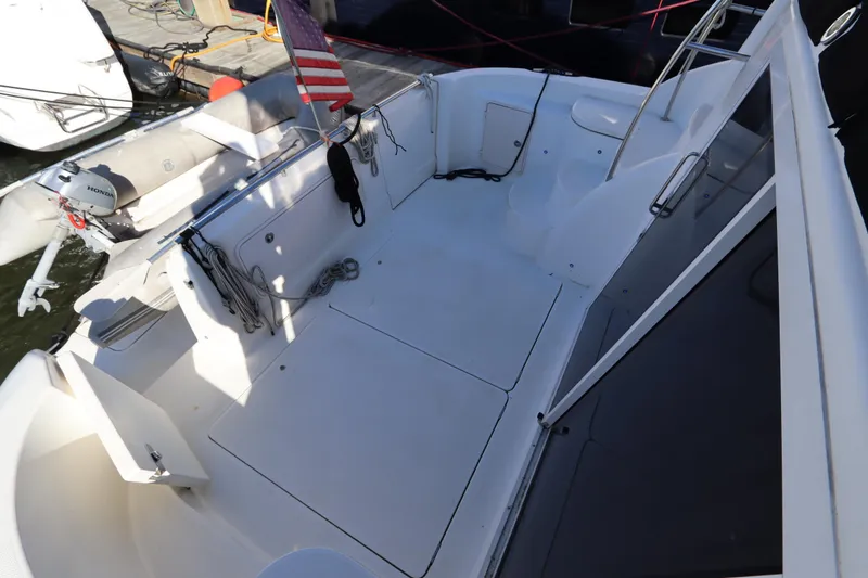 Slide: The Image of Spacious deck of 2005 Meridian 459 Motoryacht with American flag and mooring ropes. - 12