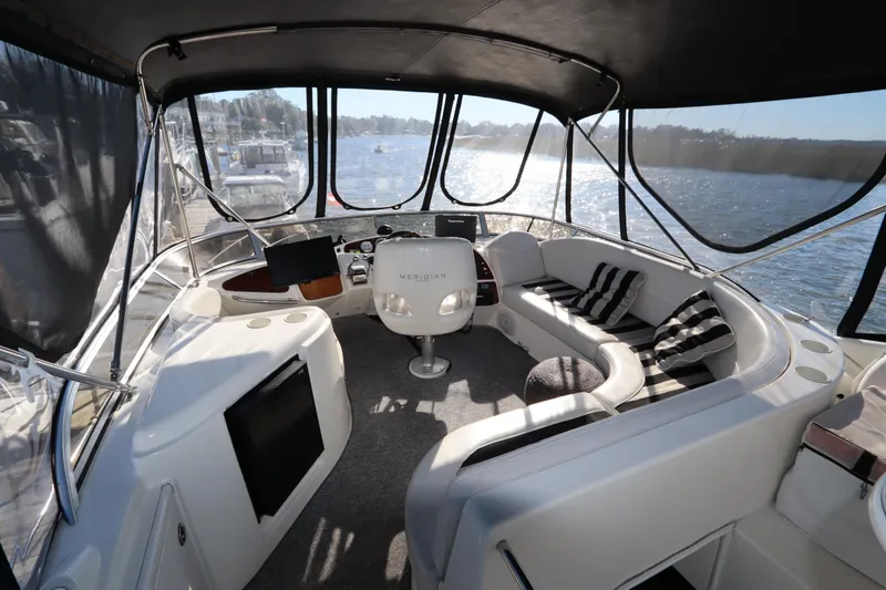 Slide: The Image of Interior of 2005 Meridian 459 Motoryacht with seating and helm, overlooking water. - 15