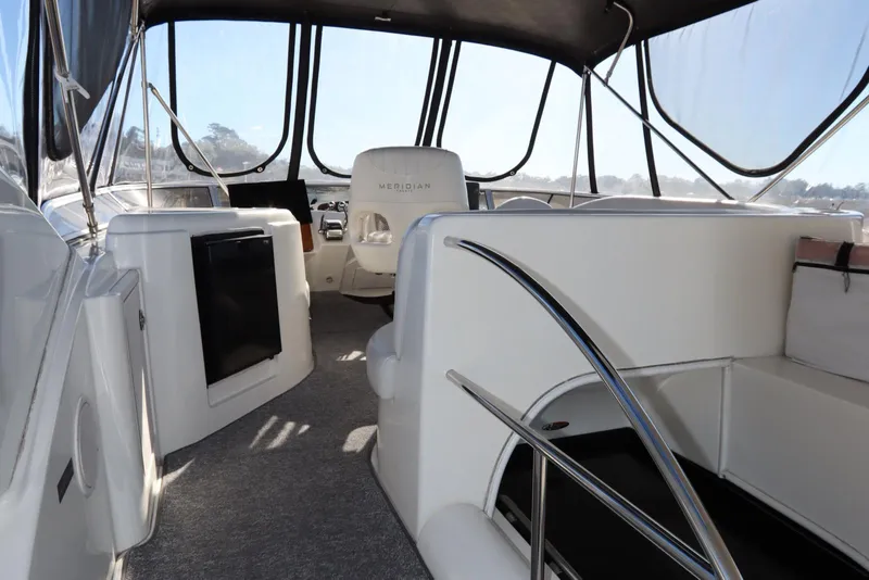 Slide: The Image of 2005 Meridian 459 Motoryacht interior with seating and helm, featuring modern design and spacious layout. - 16