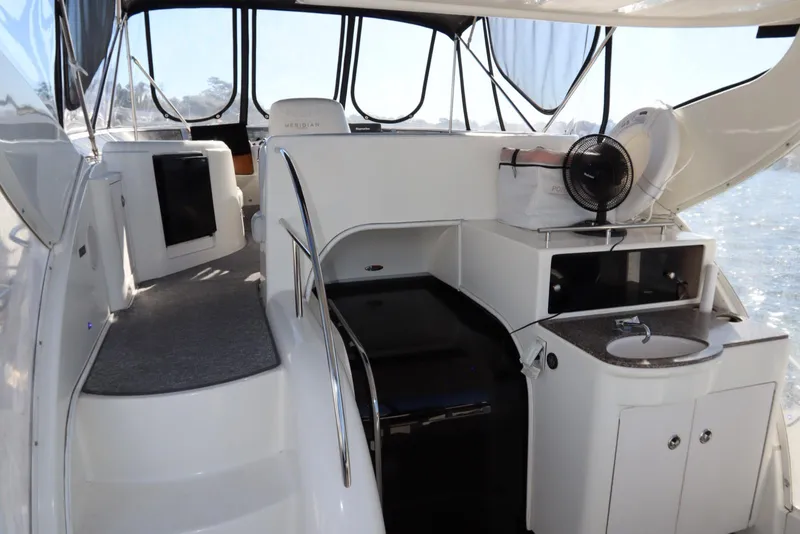 Slide: The Image of 2005 Meridian 459 Motoryacht interior with seating, sink, and storage. - 18