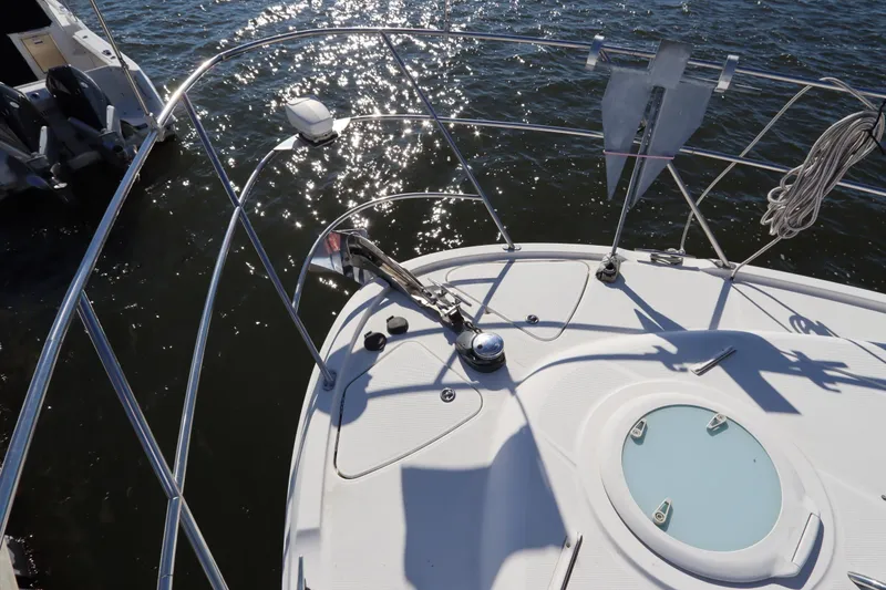 Slide: The Image of 2005 Meridian 459 Motoryacht bow with anchor, on sparkling water. - 2