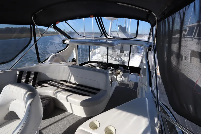 Slide: The Image of 2005 Meridian 459 Motoryacht interior with seating and helm, cruising on open water. - 28
