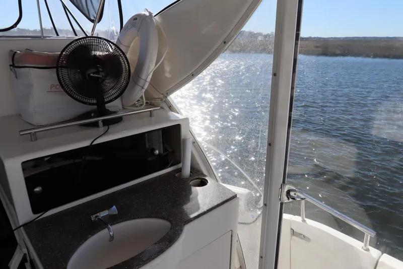 Slide: The Image of 2005 Meridian 459 Motoryacht interior with sink and lake view. - 33
