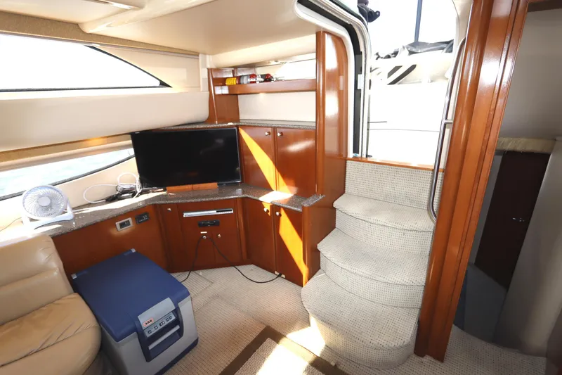 Slide: The Image of Interior of 2005 Meridian 459 Motoryacht with TV, stairs, and seating area. - 43