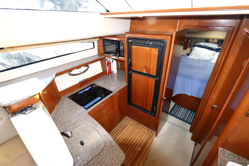 Slide: The Image of 2005 Meridian 459 Motoryacht interior with kitchen and bedroom view. - 45
