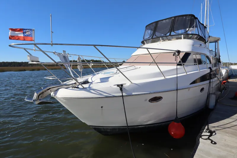 Slide: The Image of 2005 Meridian 459 Motoryacht docked on a sunny day, featuring sleek design and spacious deck. - 8
