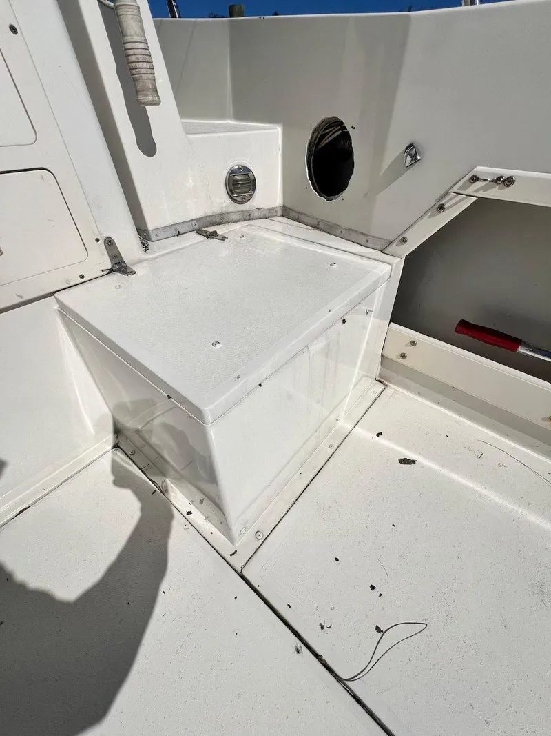 Slide: The Image of 1988 Grady-White 25 SAILFISH boat interior, white seating area, clean and well-maintained. - 25