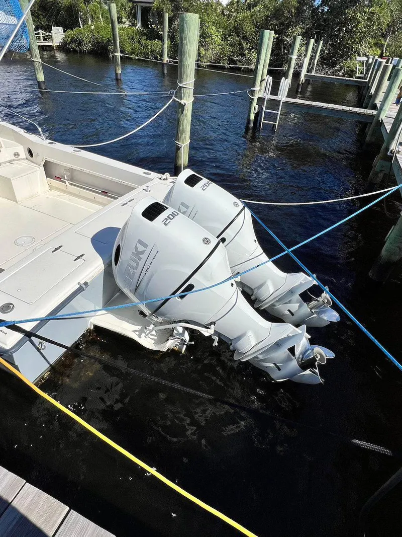 Slide: The Image of 1988 Grady-White 25 Sailfish boat with dual outboard engines docked in marina. - 3