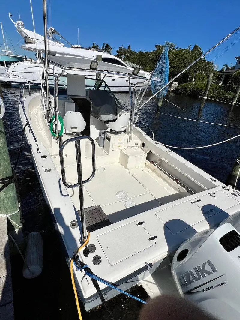 Slide: The Image of 1988 Grady-White 25 SAILFISH boat docked with Suzuki outboard motor. - 4