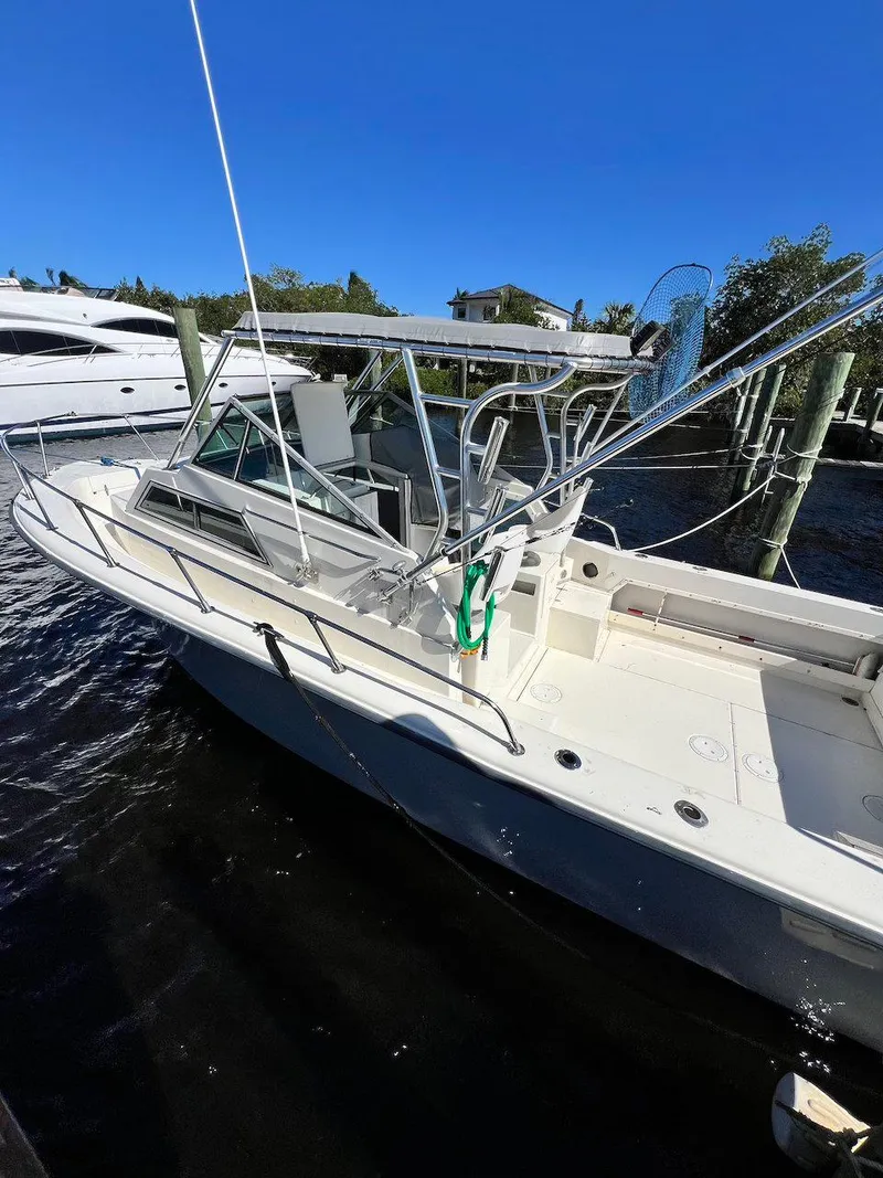 Slide: The Image of 1988 Grady-White 25 SAILFISH boat docked under clear blue sky. - 5