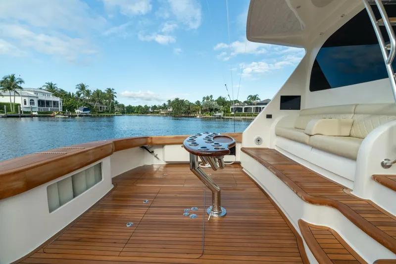 Slide: The Image of Luxurious 2021 Viking 68 Enclosed Bridge Convertible yacht with spacious teak deck and seating area. - 10