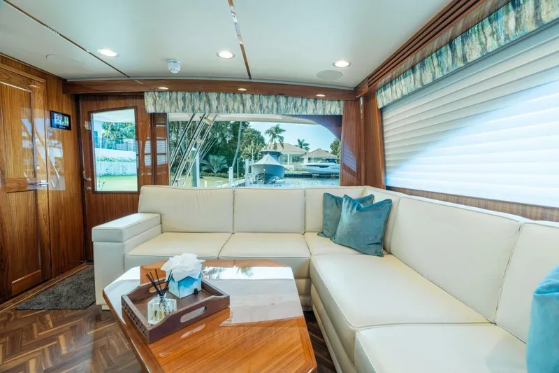Slide: The Image of Luxurious interior of 2021 Viking 68 Enclosed Bridge Convertible yacht with elegant seating. - 16