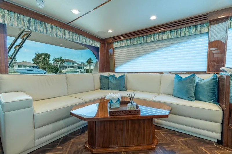 Slide: The Image of Luxurious interior of 2021 Viking 68 Enclosed Bridge Convertible yacht with elegant seating. - 17