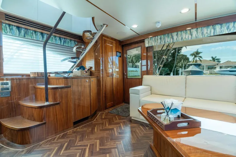 Slide: The Image of Luxurious interior of 2021 Viking 68 Enclosed Bridge Convertible yacht with elegant wood finishes. - 18
