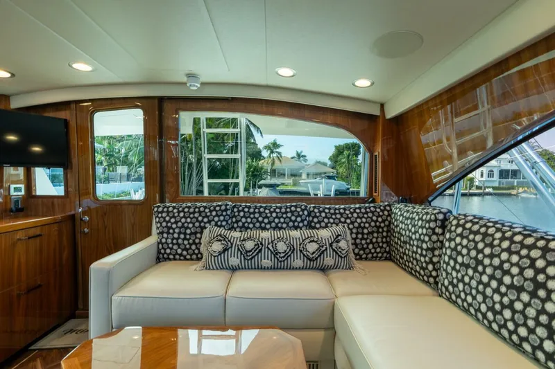 Slide: The Image of Luxurious interior of 2021 Viking 68 Enclosed Bridge Convertible yacht with plush seating. - 21