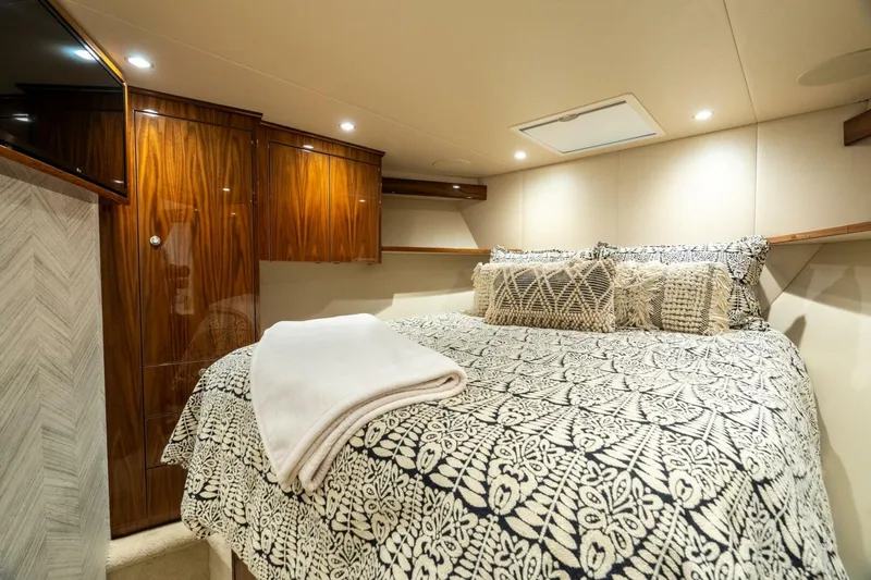 Slide: The Image of Luxurious bedroom interior of 2021 Viking 68 Enclosed Bridge Convertible yacht. - 23